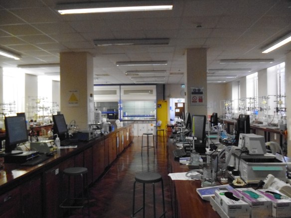 A laboratory, with polished wooden furnishings a scattering of computers and machinery.