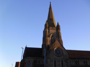 A large stone spire against a blue sky.